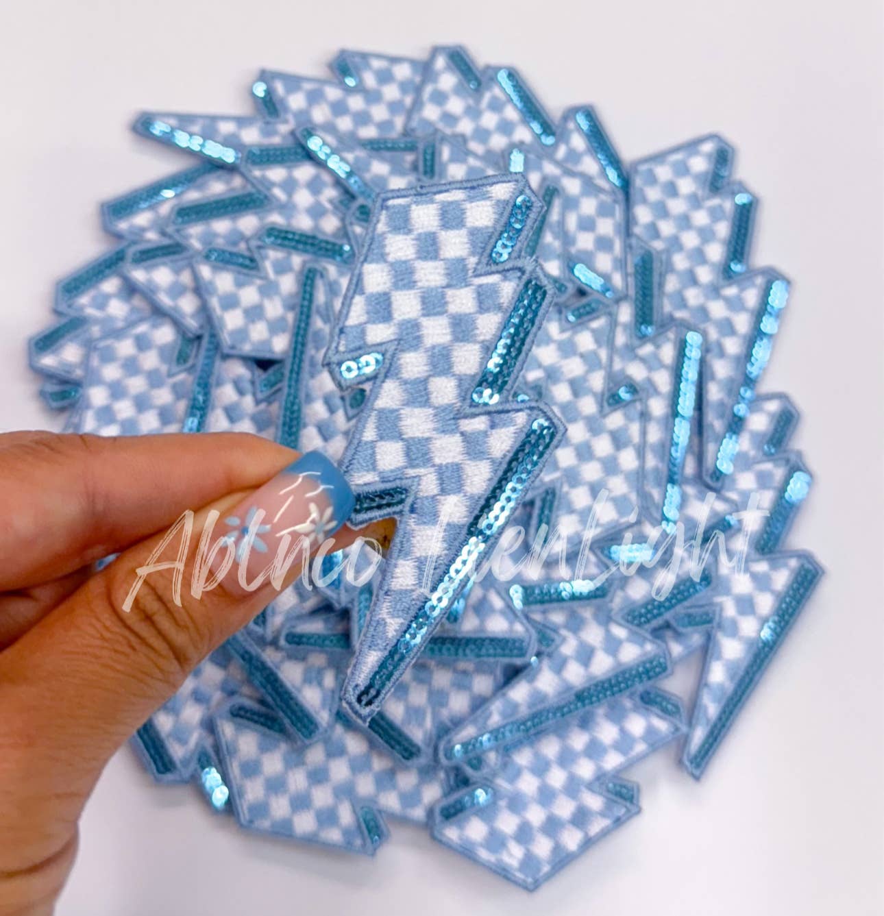 Light blue checkered lightning bolt filler patch iron on
