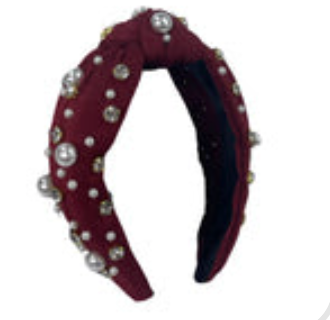 Burgundy top knot headband decorated with white pearls and clear rhinestones.