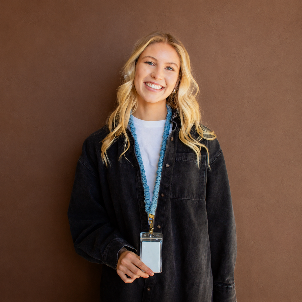 Model wearing a blue denim scrunchie lanyard with an ID badge holder attached.
