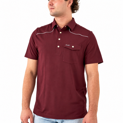 A man wearing a short-sleeve polo shirt in burgundy with white contrast stitching and a chest pocket, shown from the waist up against a plain white background.