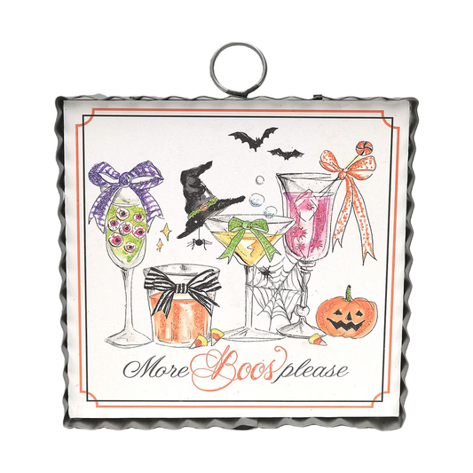 Mini framed Halloween art with illustrated cocktails, bats, a witch hat, jack-o’-lantern and “More Boos Please” lettering.