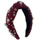 Burgundy top knot headband decorated with white pearls and clear rhinestones.