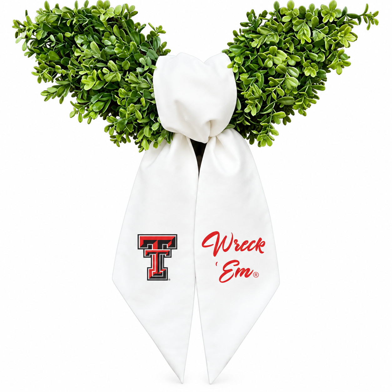 A novelty costume accessory featuring a white satin bow with red and black 'Texas Tech' logo on one side and red cursive 'Wreck 'Em' text on the other, topped with green artificial boxwood branches on a white background.