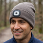 Adult wearing the taupe-gray Night Scope LED beanie