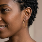 Cassie Wavy Hoop Earrings on a left-facing model