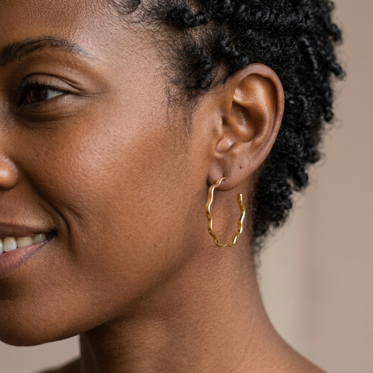 Cassie Wavy Hoop Earrings on a left-facing model