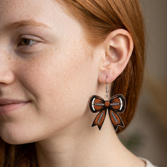 Football Bow Earrings on a teen model