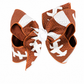 A large hair bow designed in the style of a football, featuring a brown and white textured pattern with white laces and a white center, shown on a plain white background.