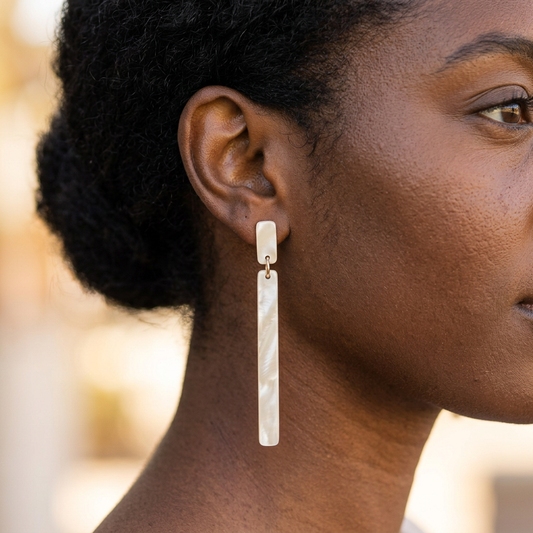 Keli Champagne Sparkle earrings on a Black model, facing right