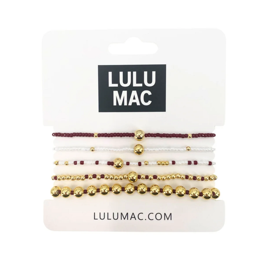 Five-piece Lulu Mac bracelet set with maroon and white beads and polished gold-tone accents.