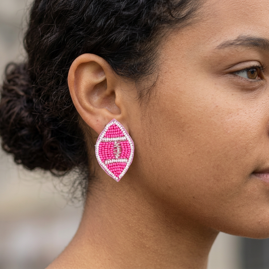 Pink and white beaded football stud on a teenage model