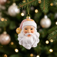 Pink and white Santa ornament hanging on a Christmas tree